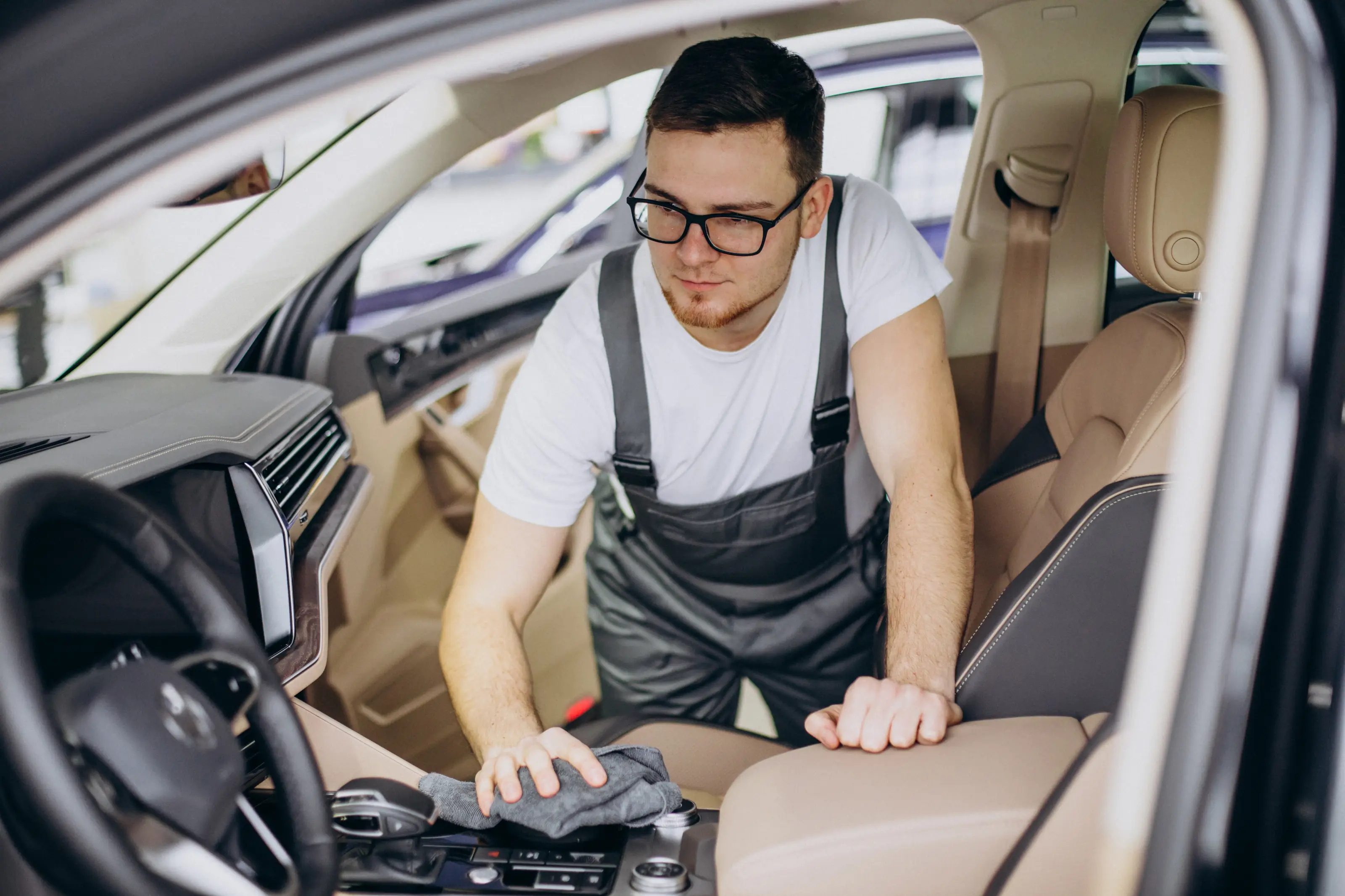Carmaa technician performing detailed interior car cleaning during a Faridabad doorstep visit